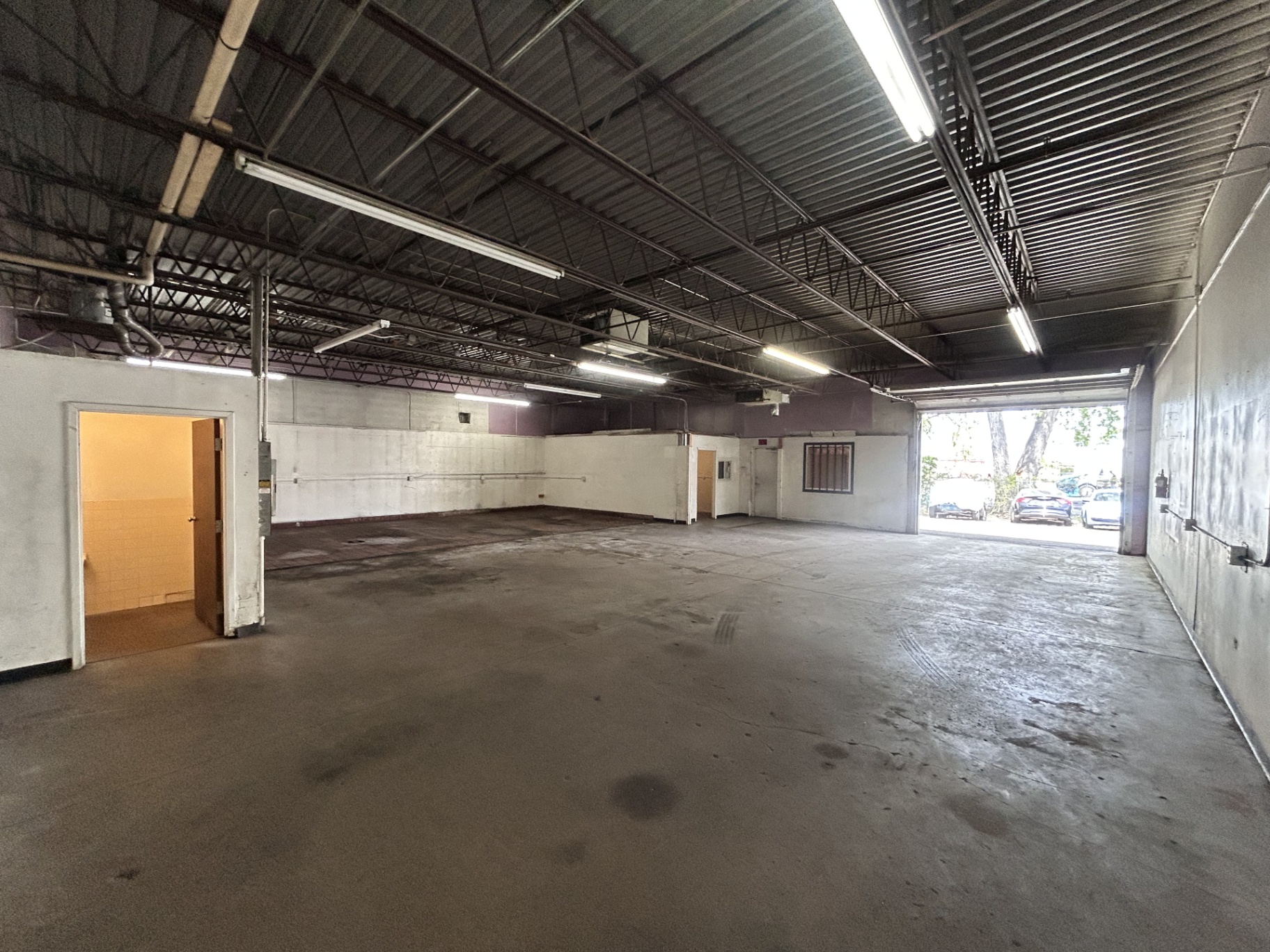Warehouse interior showing drive-in door and back wall